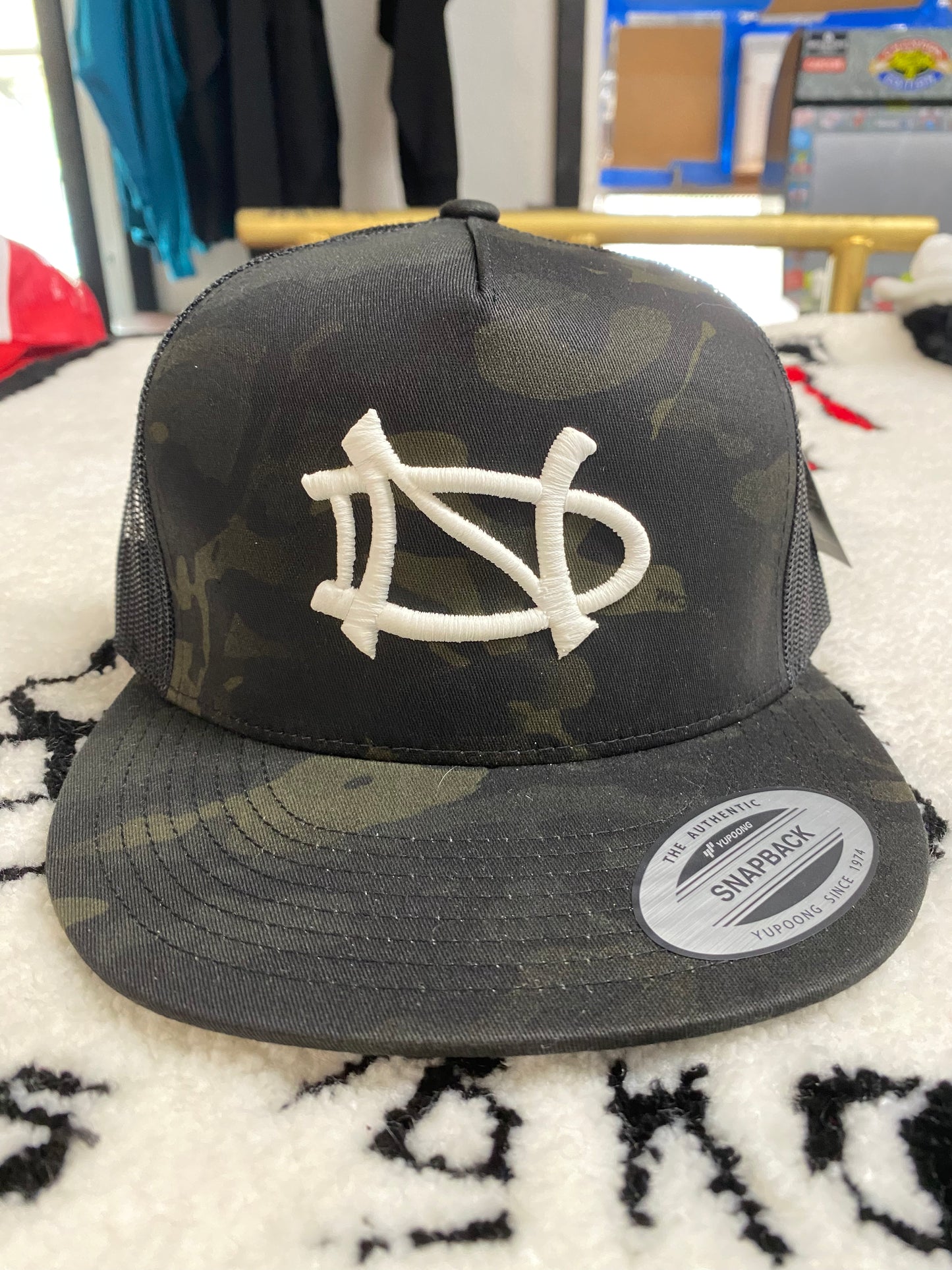 Nickel and Dime Logo Black Camouflage Trucker Hat